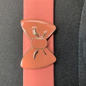 Wide leather band w/ two adj clasp. Muted orange